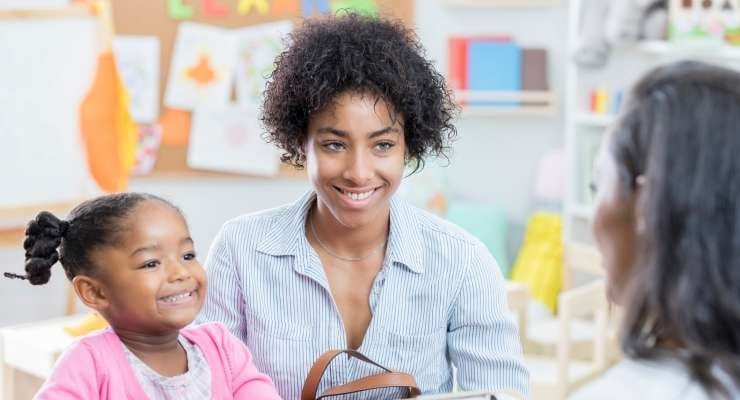 student and her mother attend a parent-teacher meeting