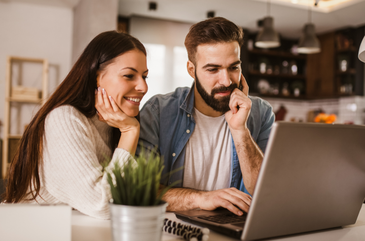 Married couple reviewing RaiseRight resources on their laptop computer