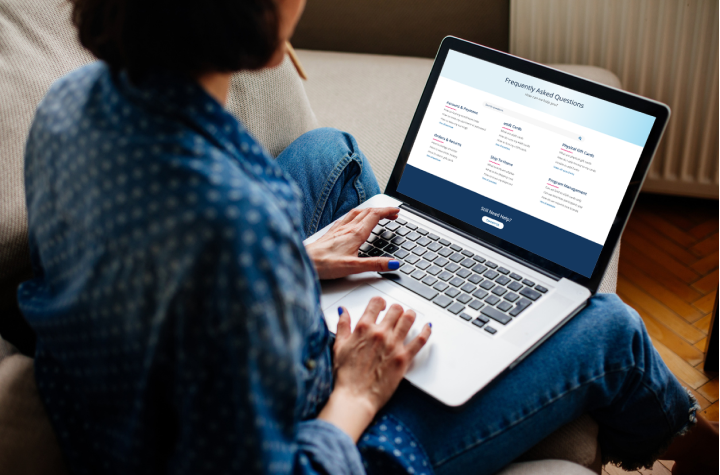 Woman on laptop reading RaiseRight's frequently asked questions