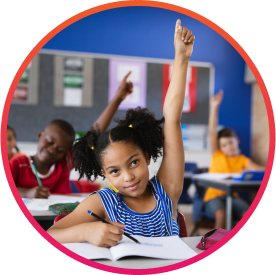 Young girl raising her hand in public school classroom