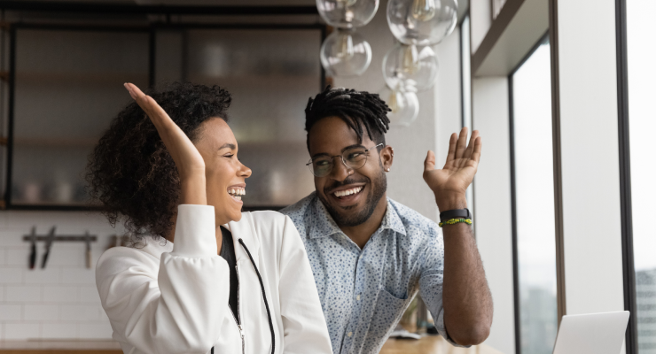 Two parents high fiving to celebrate their earnings