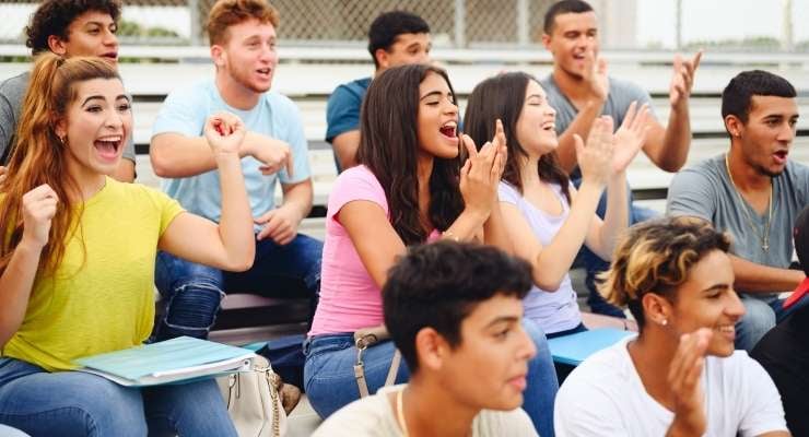 members of a booster club cheer on their favorite team