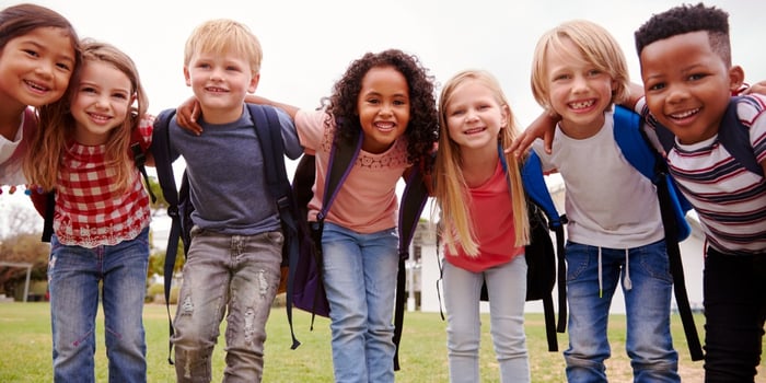 portrait-of-excited-elementary-school-pupils-on-playing-field-at-picture-id1160932512