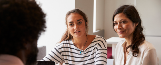 Mother and daughter meeting with a male teacher