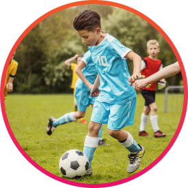 Child on fundraised soccer team dribbling the ball on the field