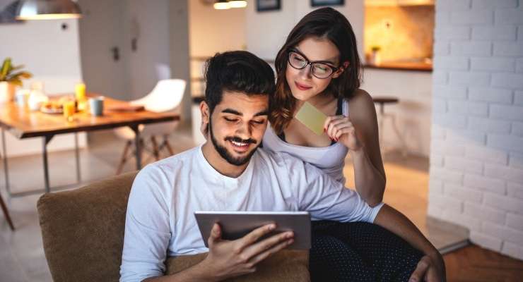 couple uses a tablet to purchase a fundraising gift card