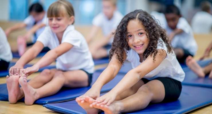 children stretch before a gymnastics class